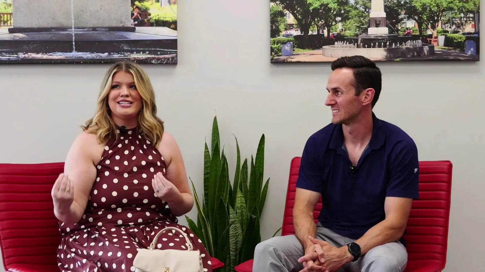 Client on camera delivering a testimonial with lights, mic, and crew—testimonial video production setup